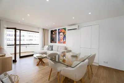 a living room with a glass table and a couch at Vilamoura Collection in Quarteira
