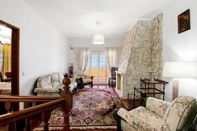 a living room with a stone wall at Quinta da Violeta in Loulé