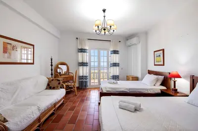 a living room with two beds and a couch at Quinta da Violeta in Loulé