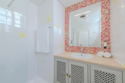 a bathroom with a sink and a mirror at The 23 Suites in Faro