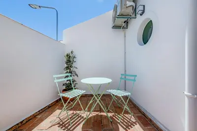 a table and two chairs in a room at The 23 Suites in Faro