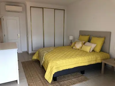 a bedroom with a bed with yellow sheets and pillows at Beach Apartment Vilamoura Villa Columbus in Vilamoura