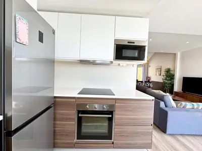 a kitchen with white cabinets and a stove at Vilamoura Marina View 4 by Homing in Vilamoura
