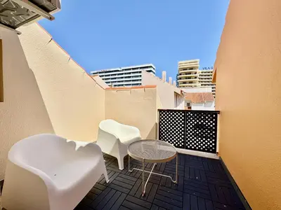 a balcony with two chairs and a table and some buildings at Vilamoura Marina View 4 by Homing in Vilamoura