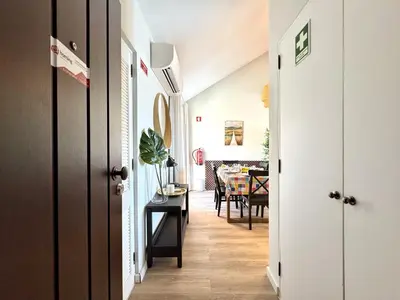 a hallway with a table and a dining room at Vilamoura Marina View 4 by Homing in Vilamoura