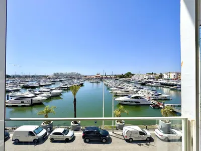 a group of cars parked in a marina with boats at Vilamoura Marina View 4 by Homing in Vilamoura