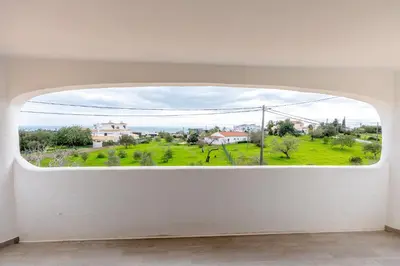 a living room with a couch and a fireplace at Casa Gralheira - Private Pool & Sea View in Albufeira