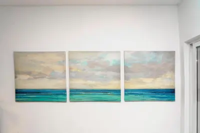 four paintings of the ocean on a wall at Apartment Maresias 120 m Oura Beach By Bedzy in Albufeira