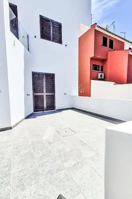 a large white room with a door and a building at Holiday Home Villa Medusa by Interhome in Vilamoura