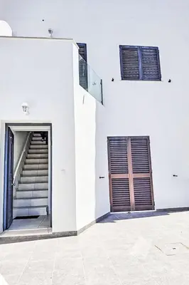 a white building with a staircase and a door at Holiday Home Villa Medusa by Interhome in Vilamoura