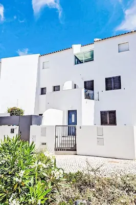 a white building with a blue door at Holiday Home Villa Medusa by Interhome in Vilamoura