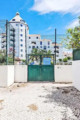 a green gate with a building in the background at Holiday Home Villa Medusa by Interhome in Vilamoura