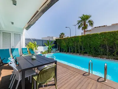 a living room with a green couch and a tv at Holiday Home Miguel VIP Properties by Interhome in Albufeira