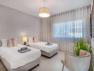 a white bedroom with a bed and a large window at Villa Vitória V3 Lote 68 - VIP Properties by Interhome in Albufeira