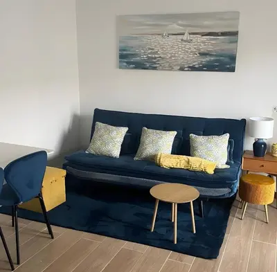 a living room with a blue couch and a table at Casa Tapada do Bento III- Albufeira in Albufeira