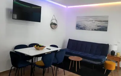 a living room with a blue couch and a table at Casa Tapada do Bento III- Albufeira in Albufeira