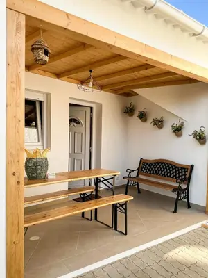 a patio with two benches and a table and a bench at Casa Rústica em Loulé - Karmea's Houses in Loulé