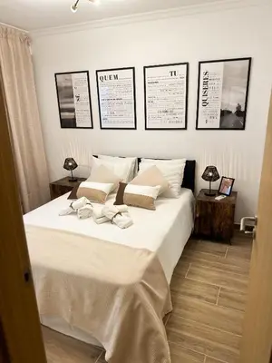 a bedroom with a white bed with two towels on it at Casa Rústica em Loulé - Karmea's Houses in Loulé