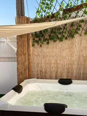 a bath tub with water in it next to a fence at Casa Rústica em Loulé - Karmea's Houses in Loulé