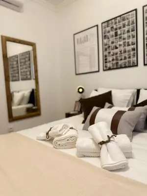 a bedroom with a bed with towels and a mirror at Casa Rústica em Loulé - Karmea's Houses in Loulé