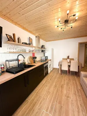 a kitchen with a counter and a dining room at Casa Rústica em Loulé - Karmea's Houses in Loulé