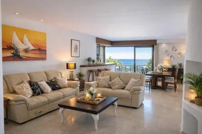 a living room with a couch and a table at Ocean Bliss II- Panoramic Sea View - 20m to Beach - 2 Swimming Pools - Private Parking in Albufeira