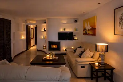 a living room with a couch and a fireplace at Ocean Bliss II- Panoramic Sea View - 20m to Beach - 2 Swimming Pools - Private Parking in Albufeira