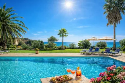 a swimming pool with a table with fruit and drinks on it at Ocean Bliss II- Panoramic Sea View - 20m to Beach - 2 Swimming Pools - Private Parking in Albufeira