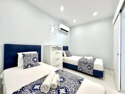 a bedroom with two beds and a dresser at Almancil Typical House by Homing in Almancil