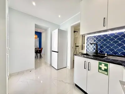 a kitchen with white cabinets and a refrigerator at Almancil Typical House by Homing in Almancil