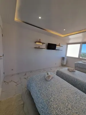 a kitchen with a couch and two bar stools at LuxPool Albufeira Stay in Albufeira