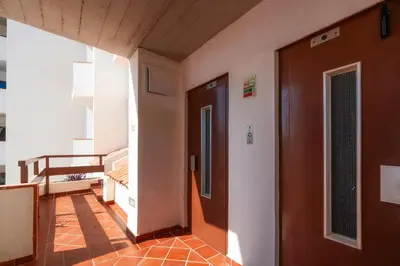 a bed with a towel on it with a pillow at LuxPool Albufeira Stay in Albufeira