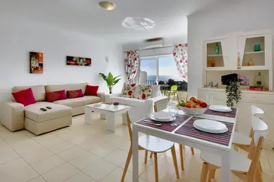 a living room with a couch and a table at Atlantic Horizon by Seareen in Albufeira