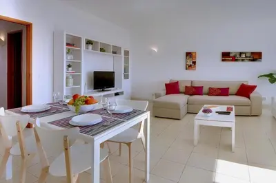 a living room with a table and a couch at Atlantic Horizon by Seareen in Albufeira