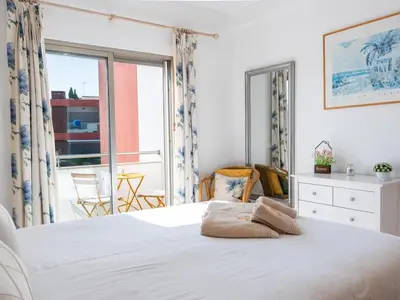 a bedroom with a white bed and a large window at Vitismar Apartment by Stay ici Algarve Holiday Rental in Guia