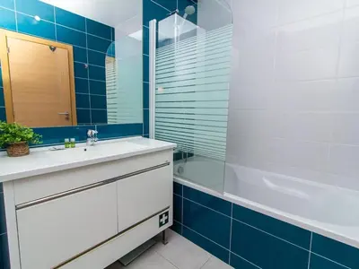 a bathroom with a sink and a tub and a mirror at Vitismar Apartment by Stay ici Algarve Holiday Rental in Guia