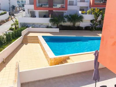 a swimming pool on the roof of a building at Vitismar Apartment by Stay ici Algarve Holiday Rental in Guia