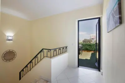 a staircase in a house with a glass door at Apartamento Perfeito in Albufeira