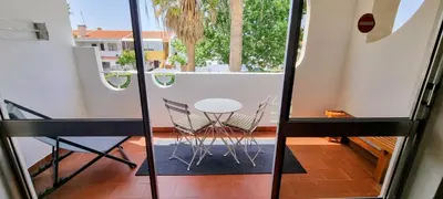 a view of a balcony with a table and chairs at Appartement Touristique dans une résidence Hôtelière Silchoro in Albufeira