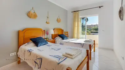 two beds in a room with a balcony at Greice Homes - T2 - JV - Vilamoura Centre in Quarteira