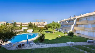 an apartment with a swimming pool and a building at Greice Homes - T2 - JV - Vilamoura Centre in Quarteira
