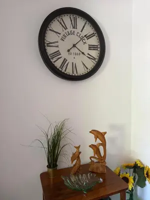 a clock hanging on a wall above a table at Costa Mar by Albufeira Rental in Olhos de Água