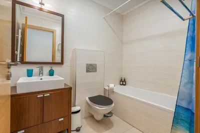 a bathroom with a sink and a toilet and a tub at Casa Vista Brejos in Albufeira