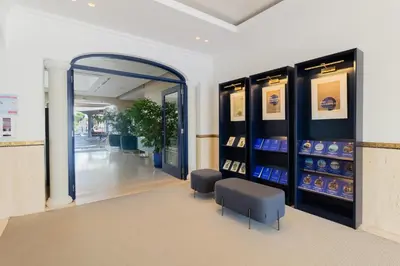 a store with a mirror and two stools in a room at Dunas Douradas Beach Club in Vale do Lobo