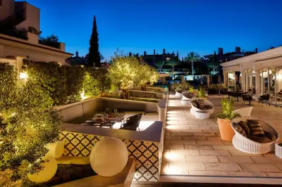 a rooftop patio with a fire pit and plants at Dunas Douradas Beach Club in Vale do Lobo