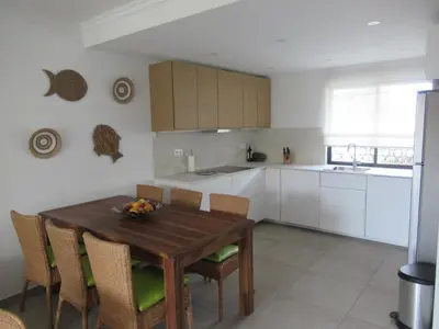 a kitchen with a wooden table and chairs at Solar dos Pinheiros T3 in Vilamoura