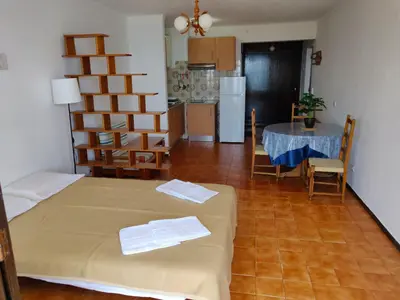 a room with a bed and a table and a kitchen at Sea Paradise in Albufeira