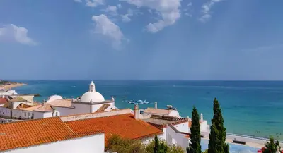 a view of a town with the ocean in the background at Sea Paradise in Albufeira