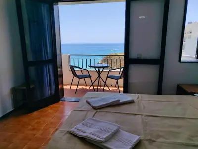a room with a bed with a view of the ocean at Sea Paradise in Albufeira