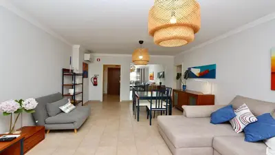 a living room with a couch and a table at Mediterraneo 2ºB - CD 318, Cleverdetails - sleeps 2 adults and 1 child in Vilamoura